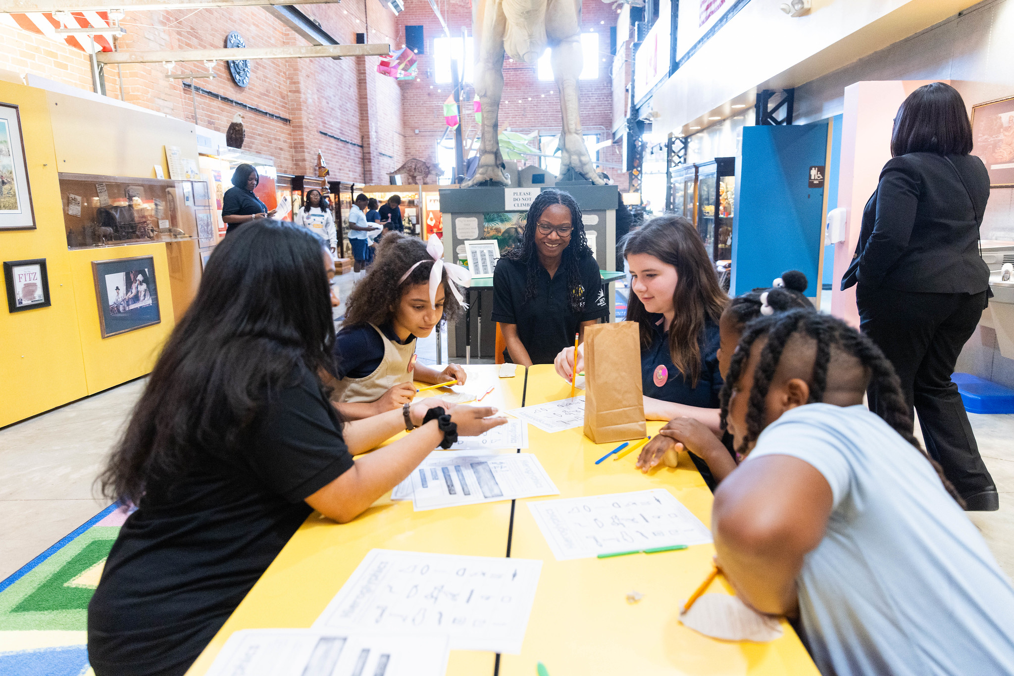 Detroit students taking part in a hands-on activity with a guide at Detroit's Children Museum