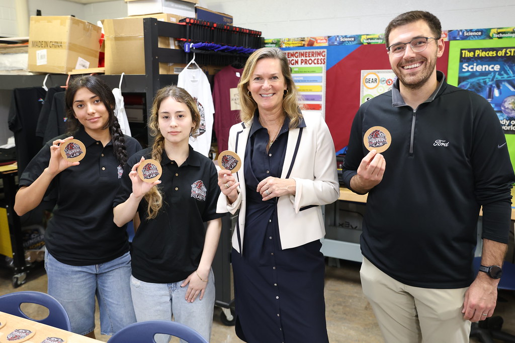 Students show their projects to a guest during the lab opening