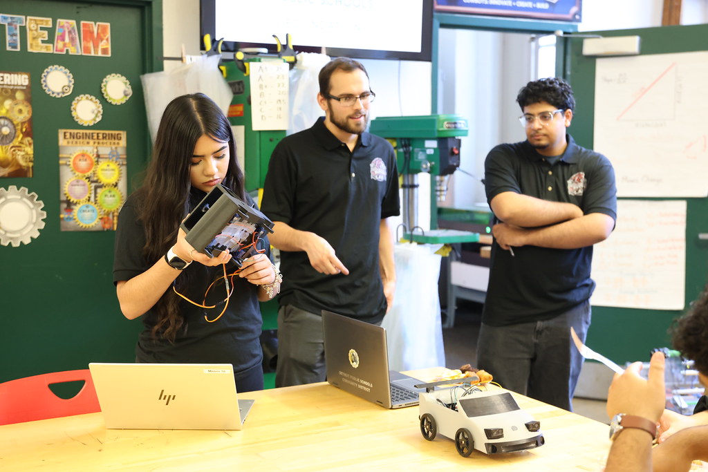 A student demonstrates a robotics project in the Ford Future Builders Lab