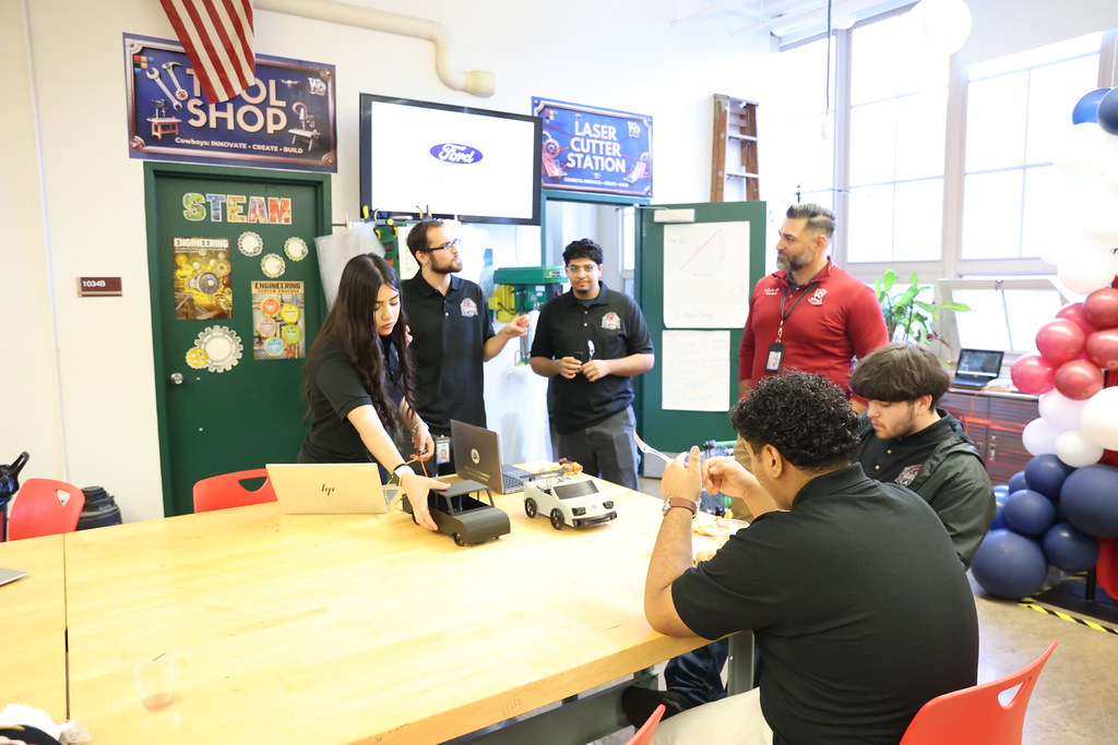 Students gathered around an opening-day activity table in the lab